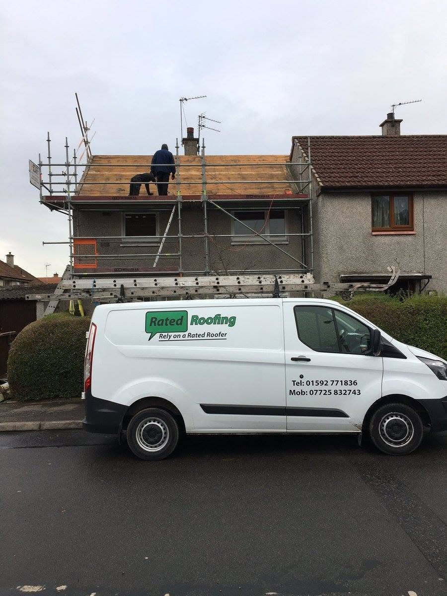 Rated Roofing team carrying out a residential roof replacement with scaffolding and company van