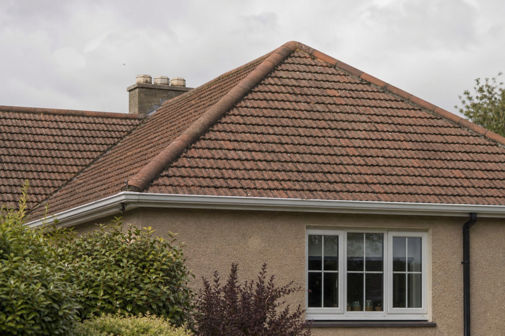 Sloping junction of a tiled hip roof on a Scottish residential property