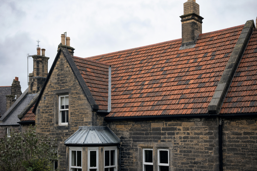 Pitched tiled roof and ridge details on a traditional Scottish residential property